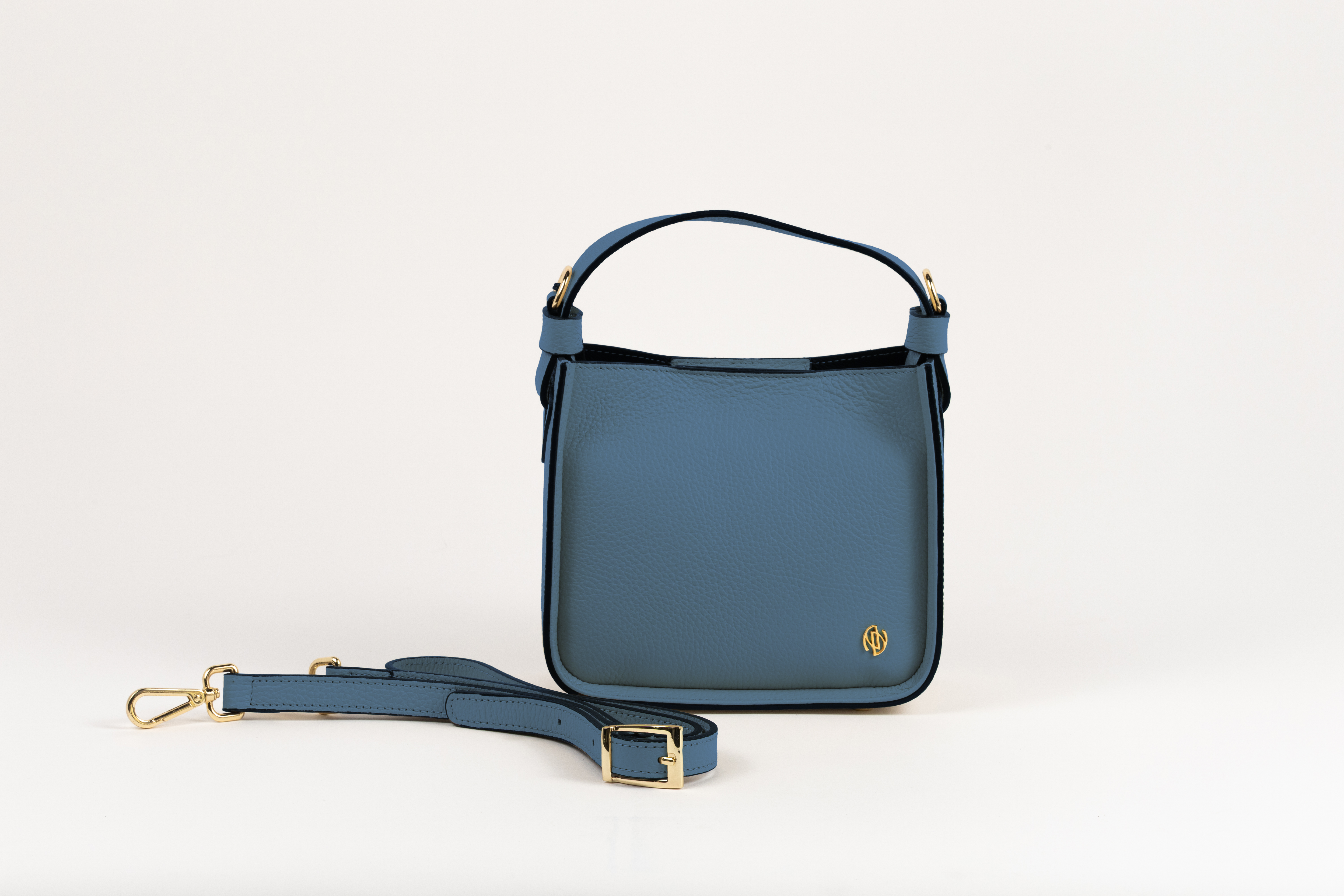 Affinée Élan Ocean handbag, front view with the shoulder strap placed beside it