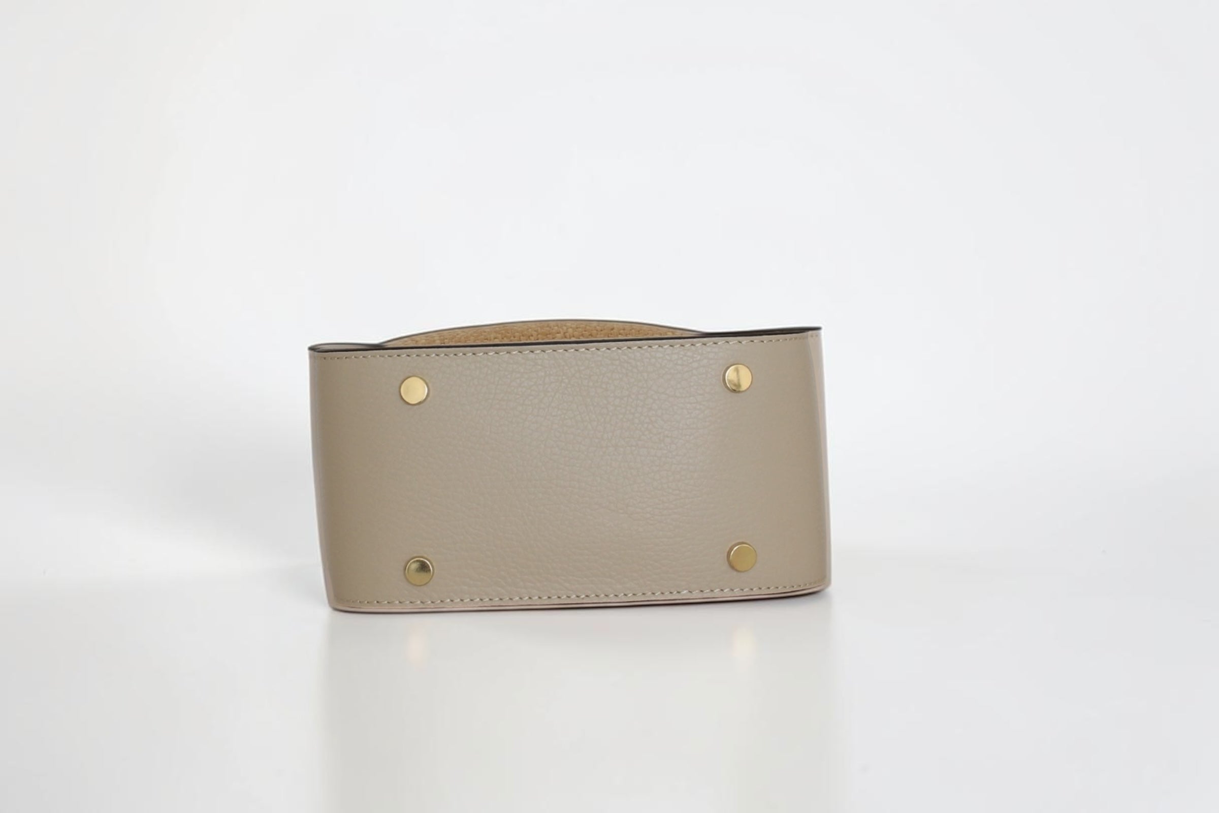 Affinée Élan Ivory handbag, base view showing the protective gold-tone feet
