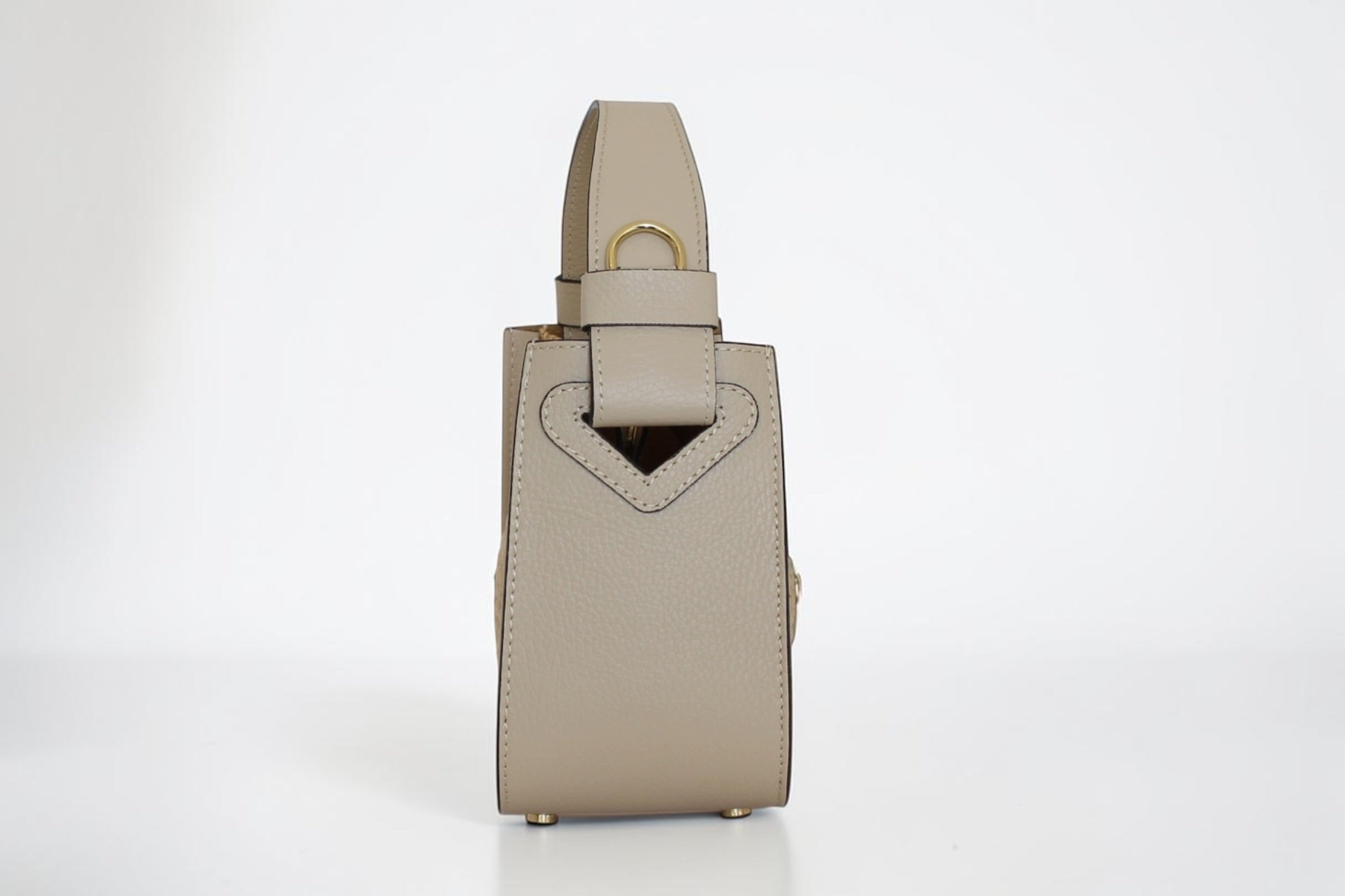 Affinée Élan Ivory handbag, side profile showing the handle attachment
